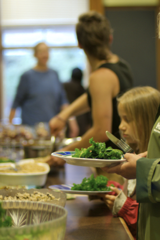 Eating raw young kale: at a community fundraising supper