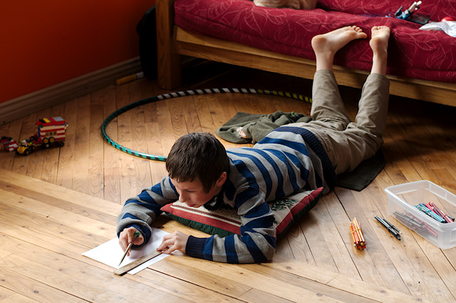 boy drawing on floor