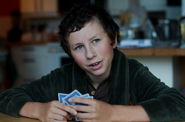 boy thinking playing cards