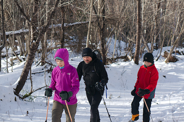 family hiking in the snow