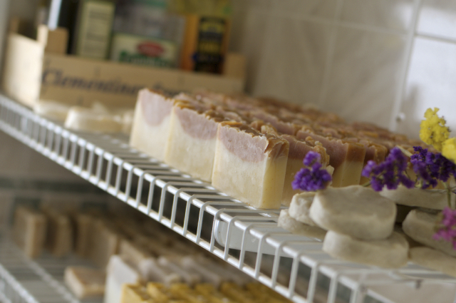 Top shelf: oils, newest (unnamed) soap, tea tree shaving soap: Bottom shelf: lemon, garden mint, orange blossom special