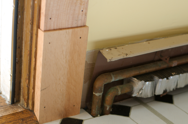 unfinished woodwork and radiator in kitchen