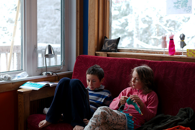 girl knitting on couch