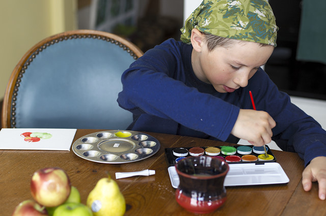 boy paints apples