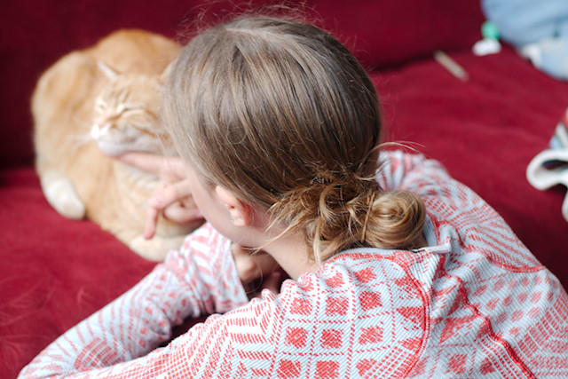 girl petting cat