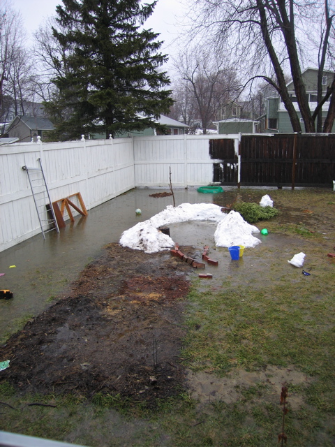 April Rain storm: The snow fort melting while our backyard floods.