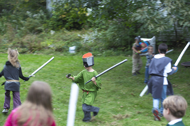 warrior boy swings foam sword